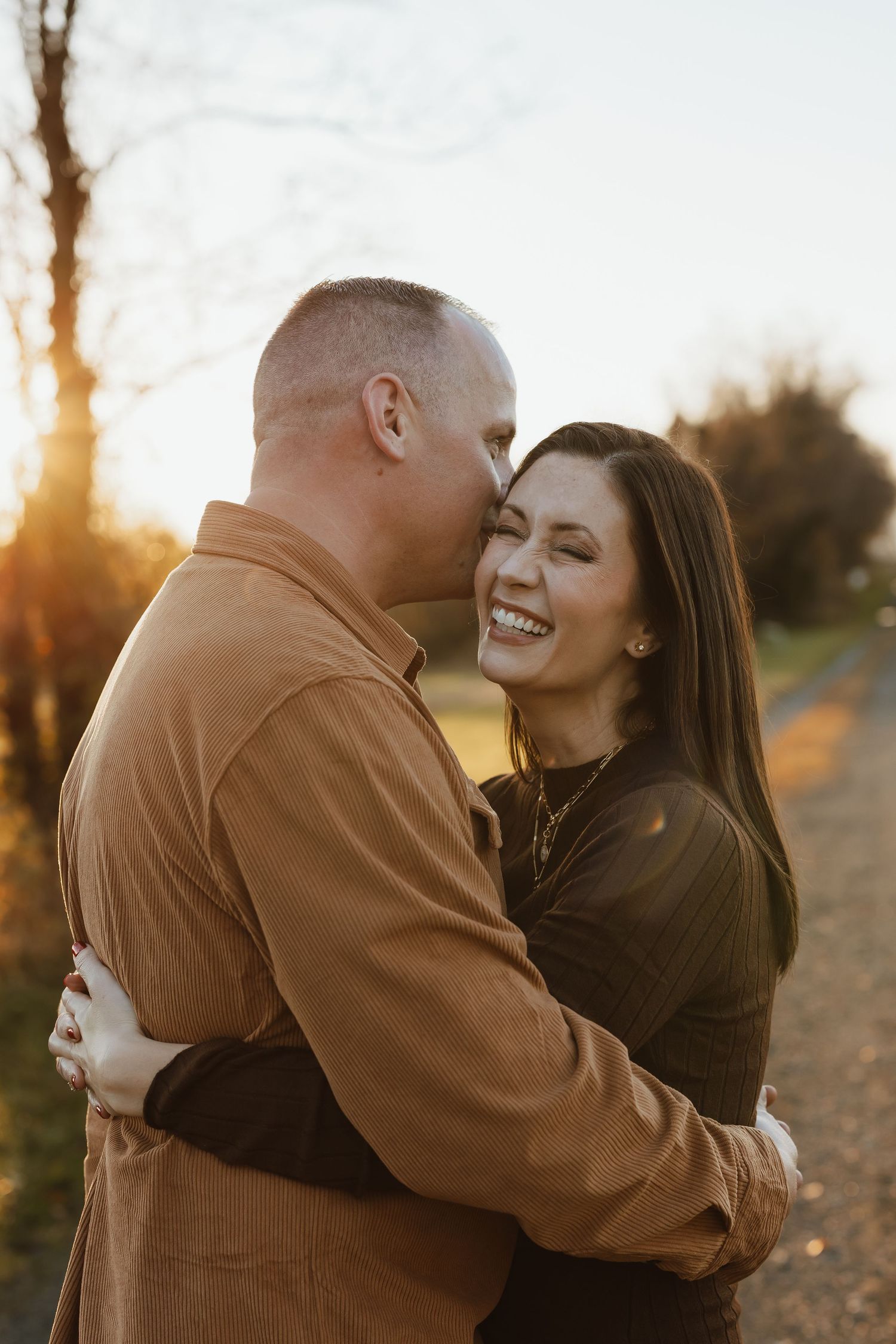Romantic couple embracing at sunset in golden light while sharing intimate moments in a series of candid shots.