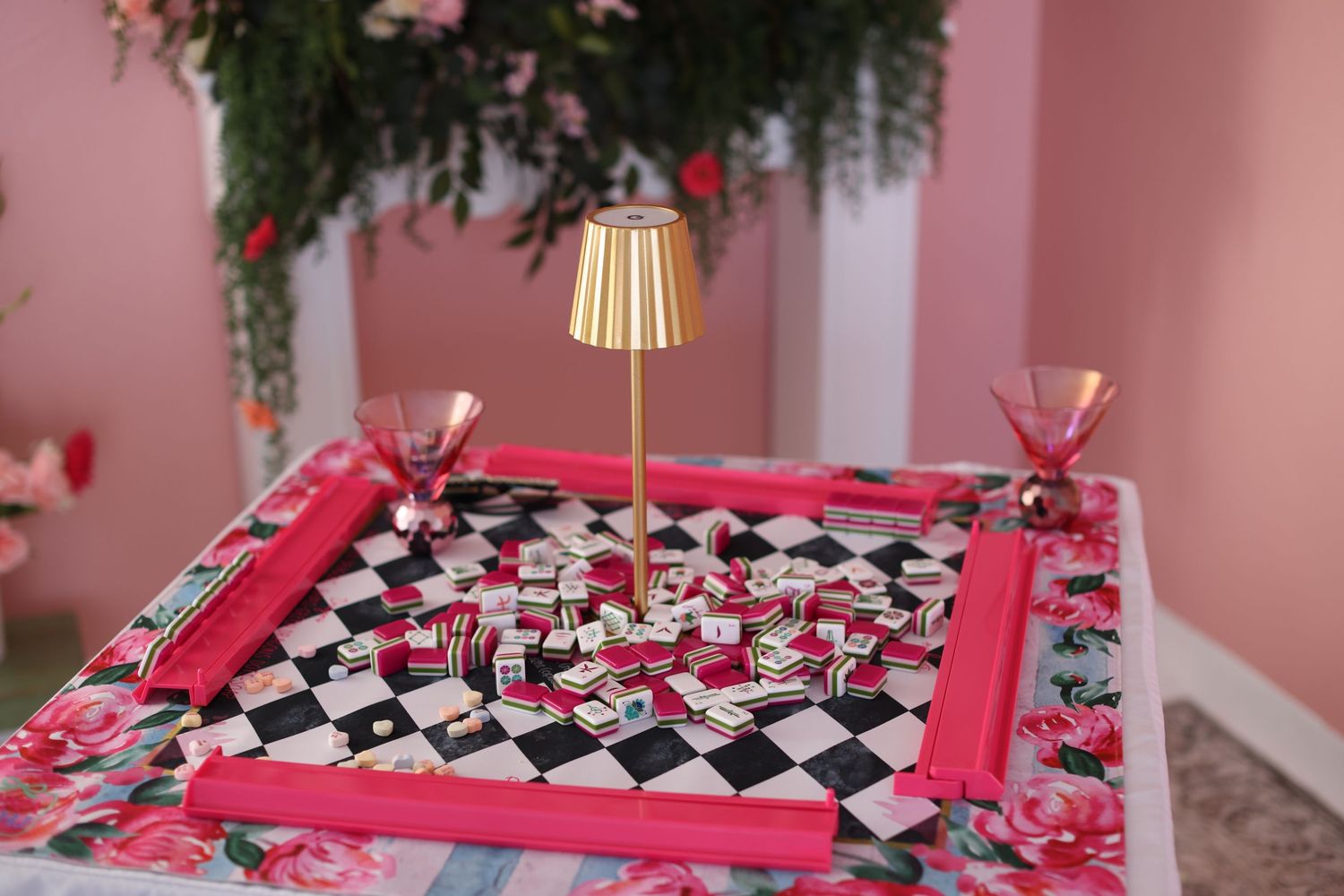 Pink and black gift boxes arranged in a decorative pattern with bows and ribbons at a party celebration.