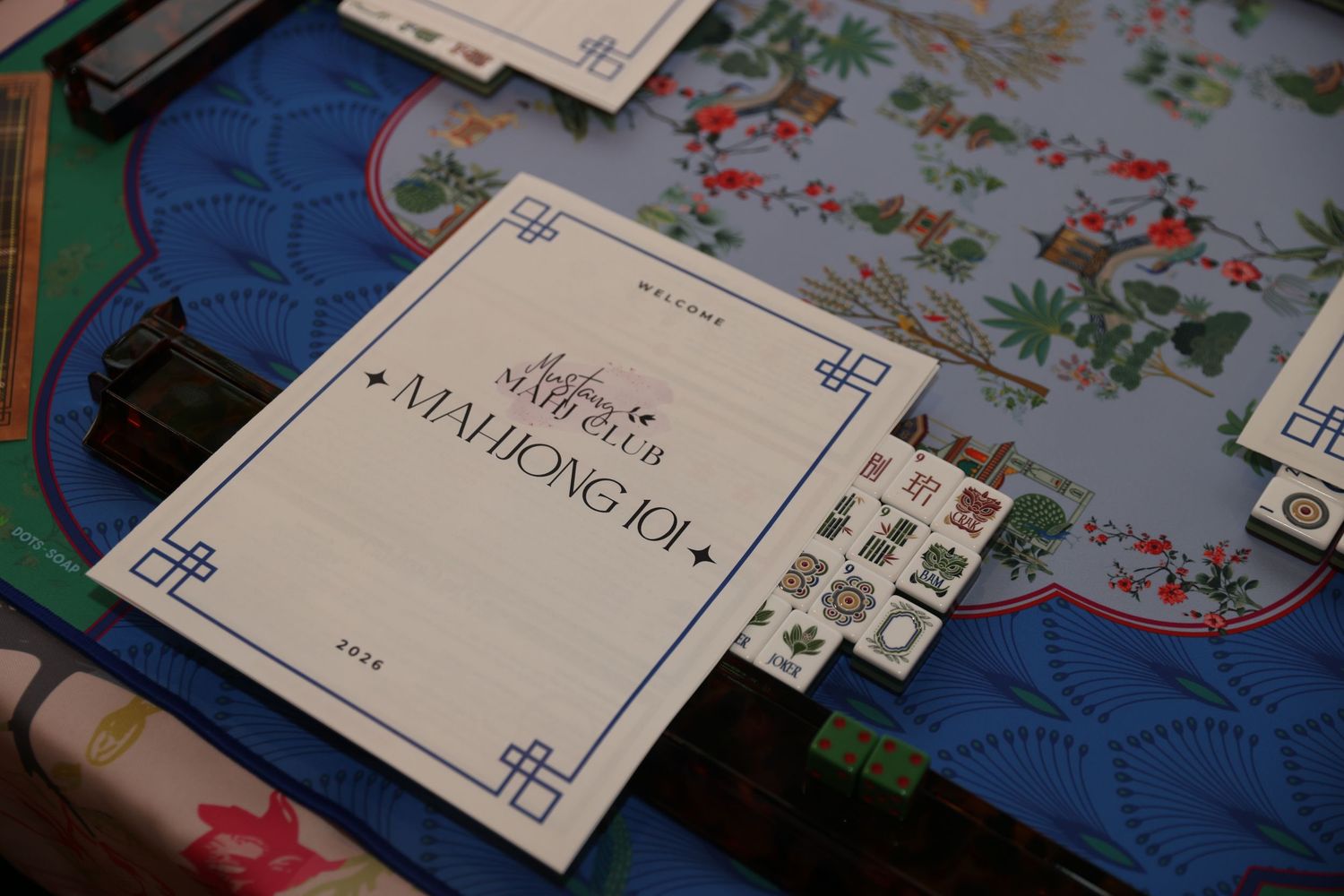 Scattered papers and documents on a floral patterned surface with blue elements in the background.
