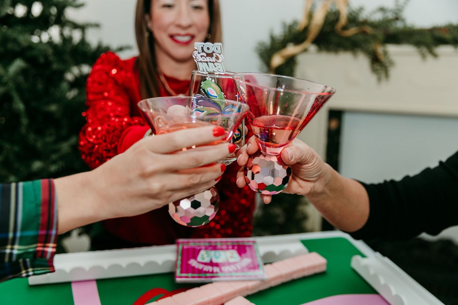 Holiday gathering with festive drinks being shared in decorative glasses.