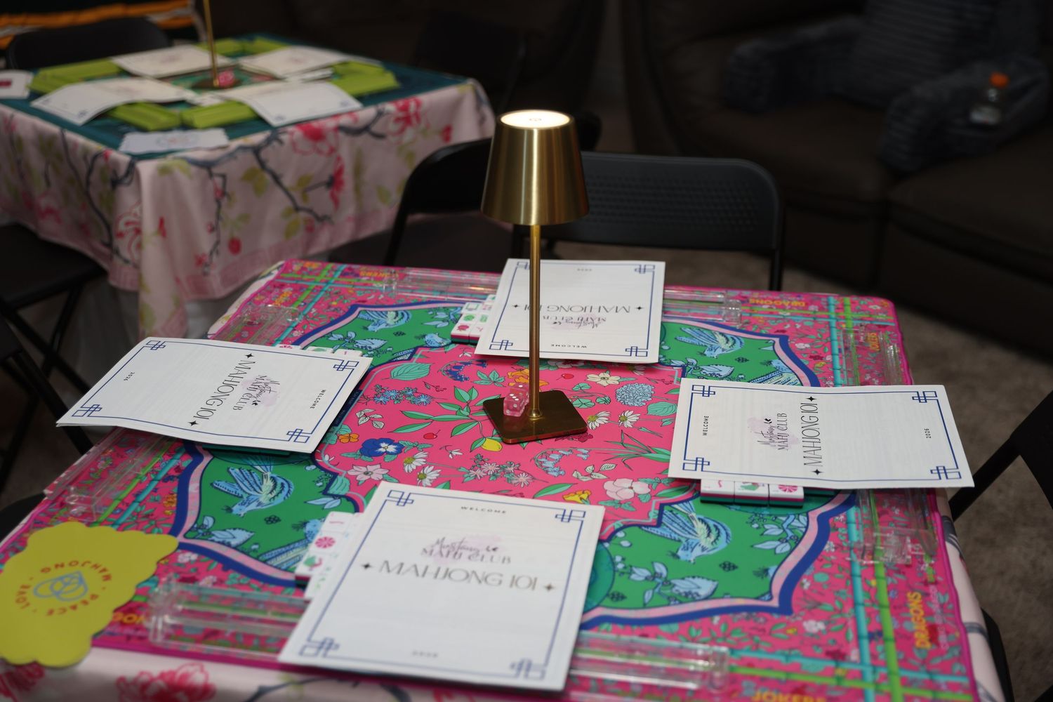 A collection of colorful art projects and papers displayed on a dark table with attached notes and labels.