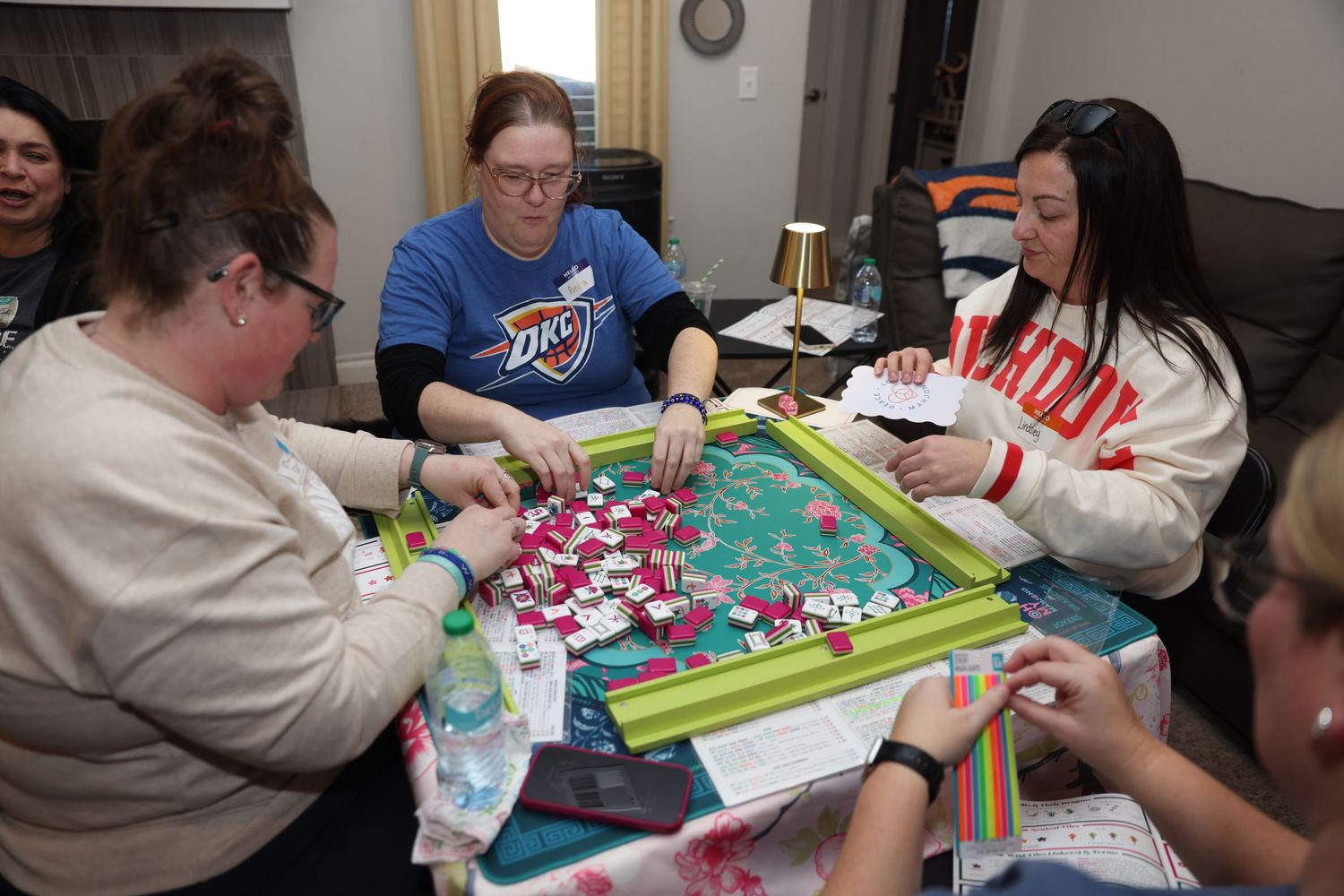 A group of people gathered around a table working on crafts and creative projects together.