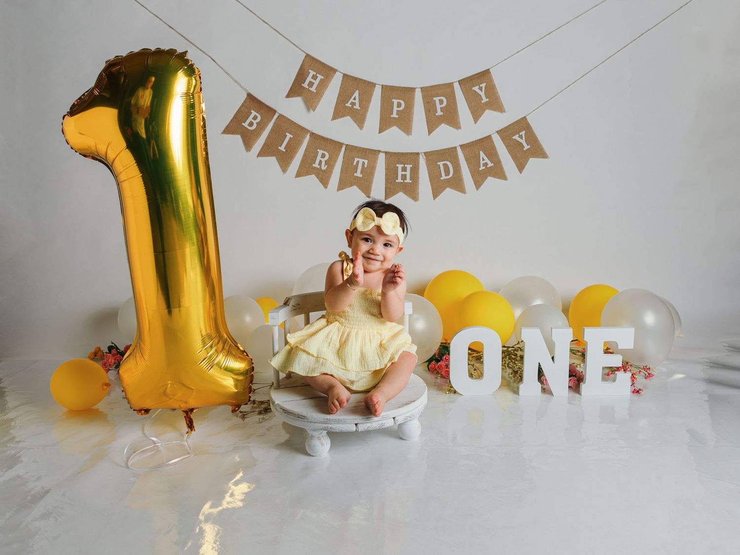 Birthday celebration scene with gold number one balloon and festive party decorations.