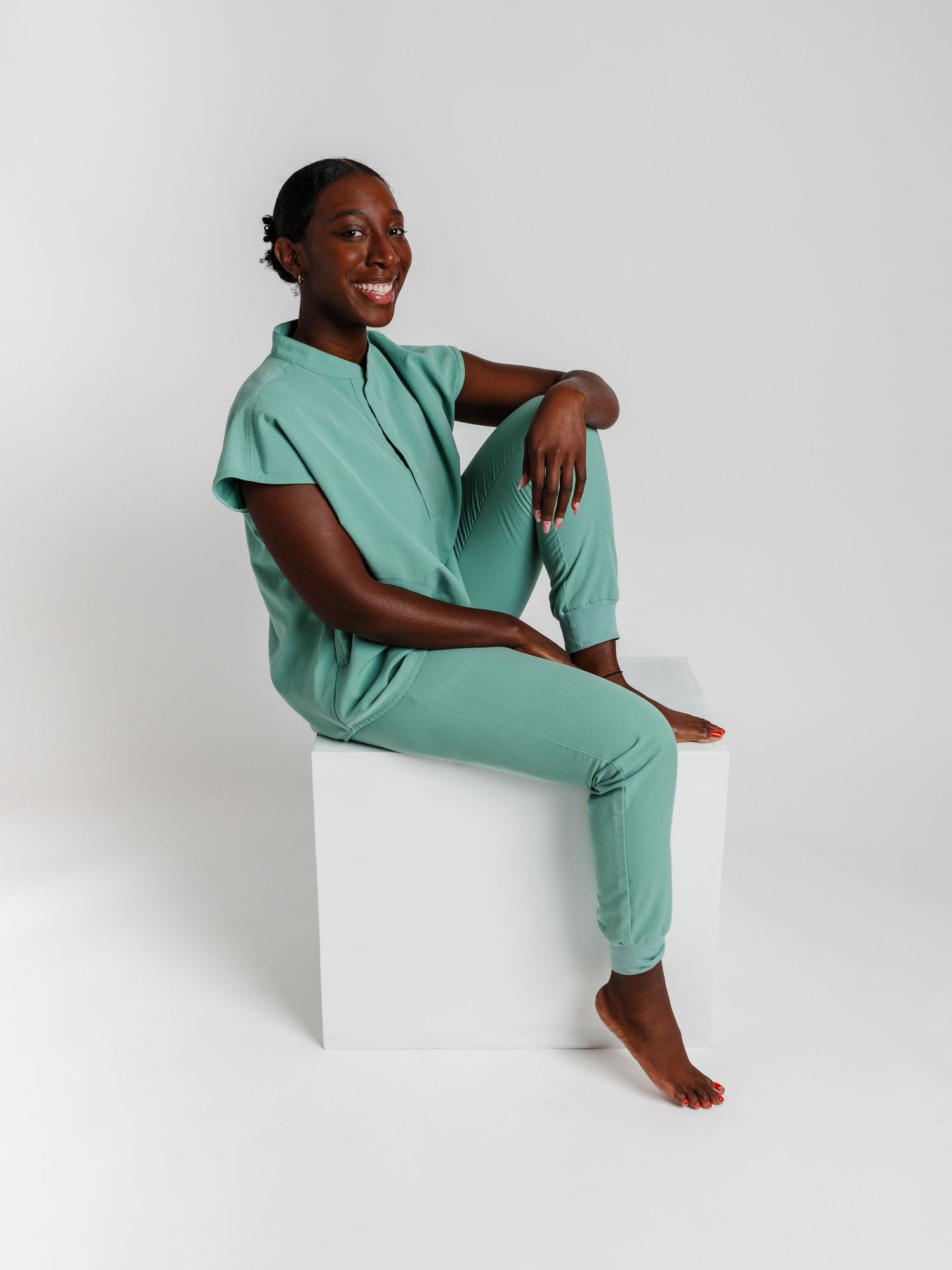 Person in mint green loungewear poses against white backdrop in various relaxed positions.