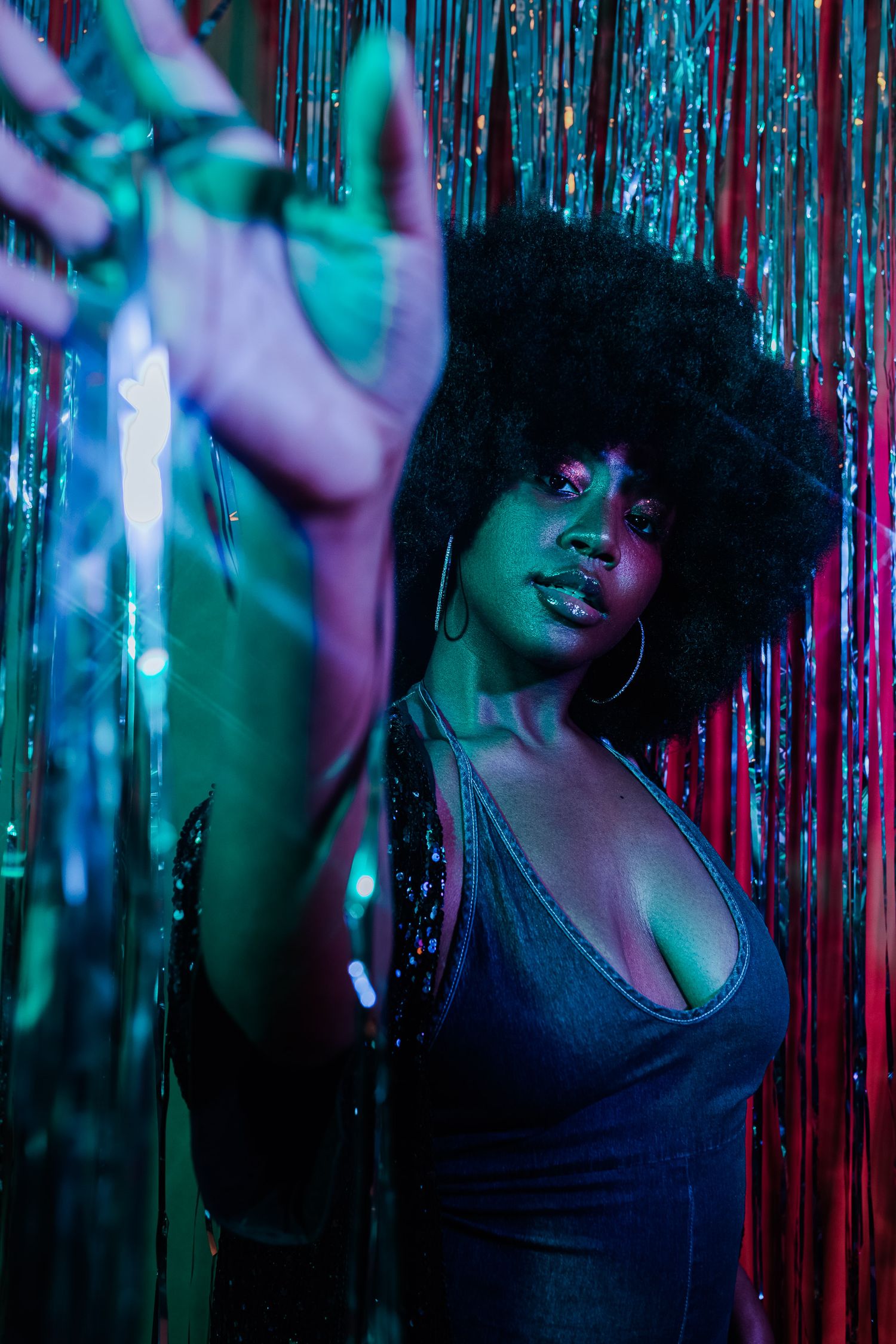 Dance-inspired portrait with dramatic poses against shimmering tinsel backdrop.