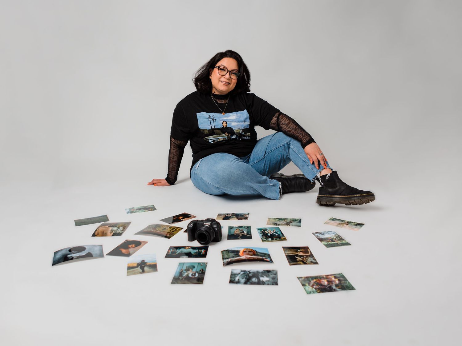 Studio photography session with prints laid out on wooden floor.