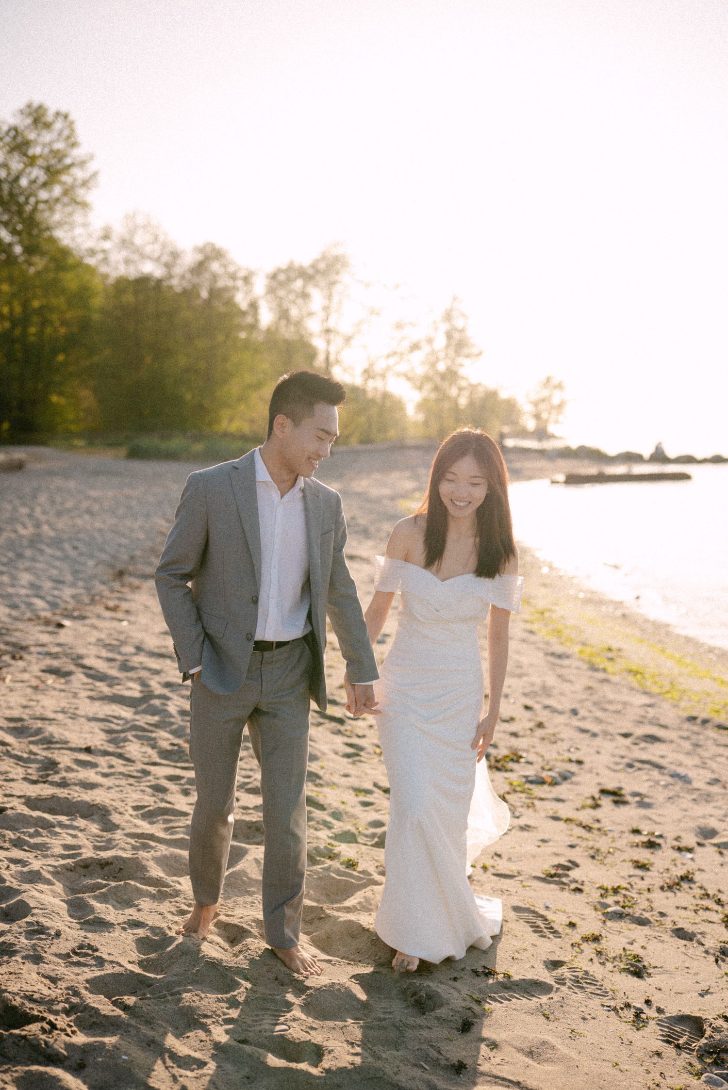 Couple walking along Spanish Banks beach. Vancouver prewedding and engagement by Victor Li Photography.