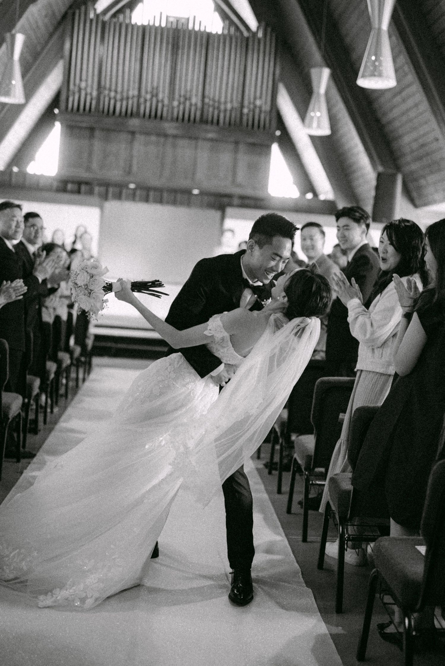 Bride and groom recessional mid-aisle dip. Vancouver wedding by Victor Li Photography.