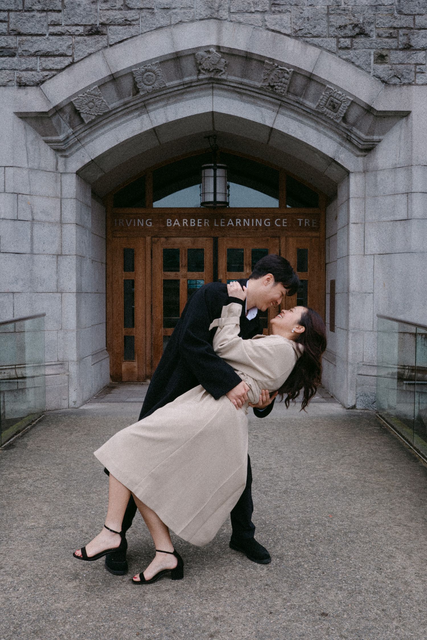 Couple dance dip in front of UBC Irving. Vancouver engagement by Victor Li Photography.