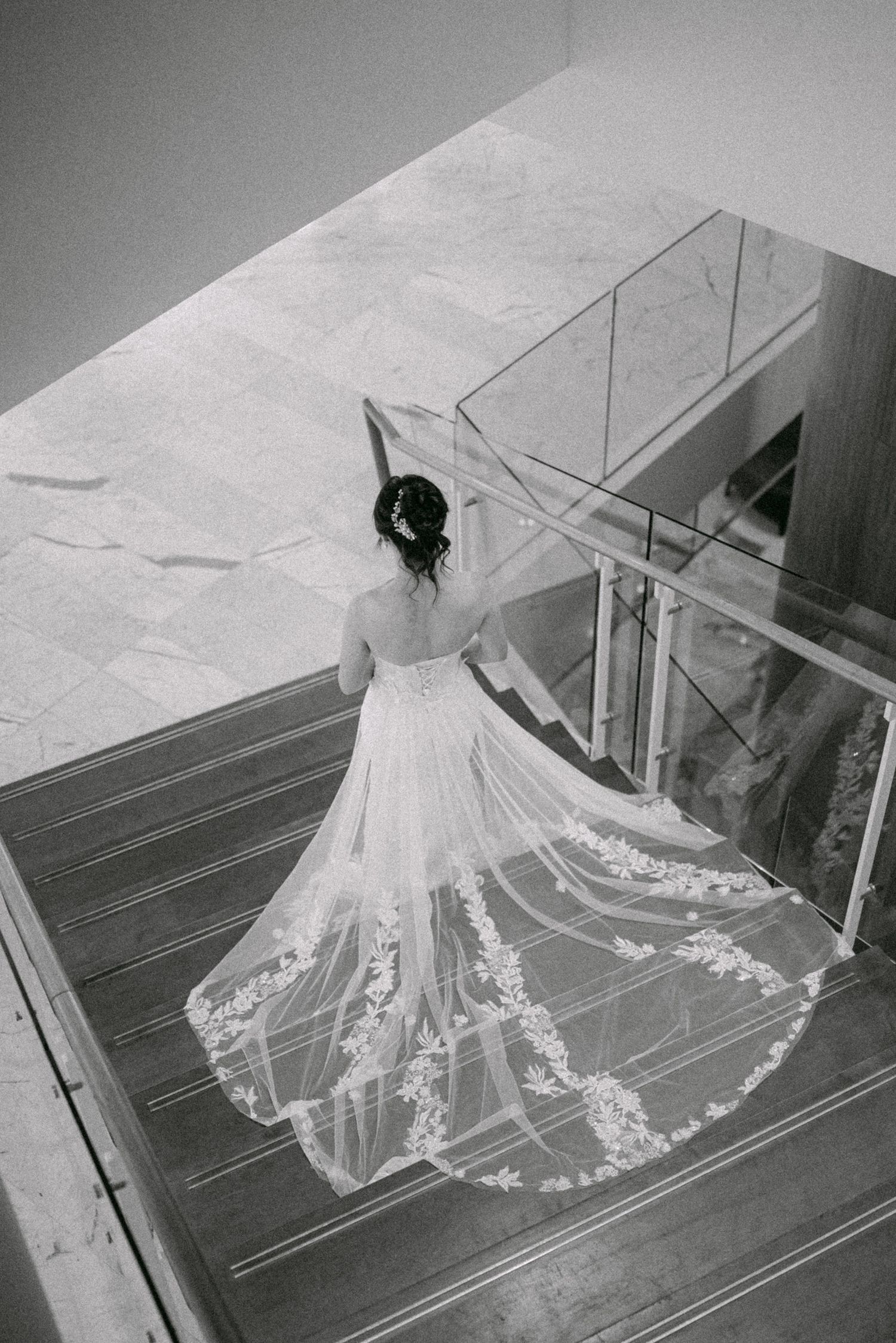 Bride walking down stairs to her first look. Vancouver wedding by Victor Li Photography.