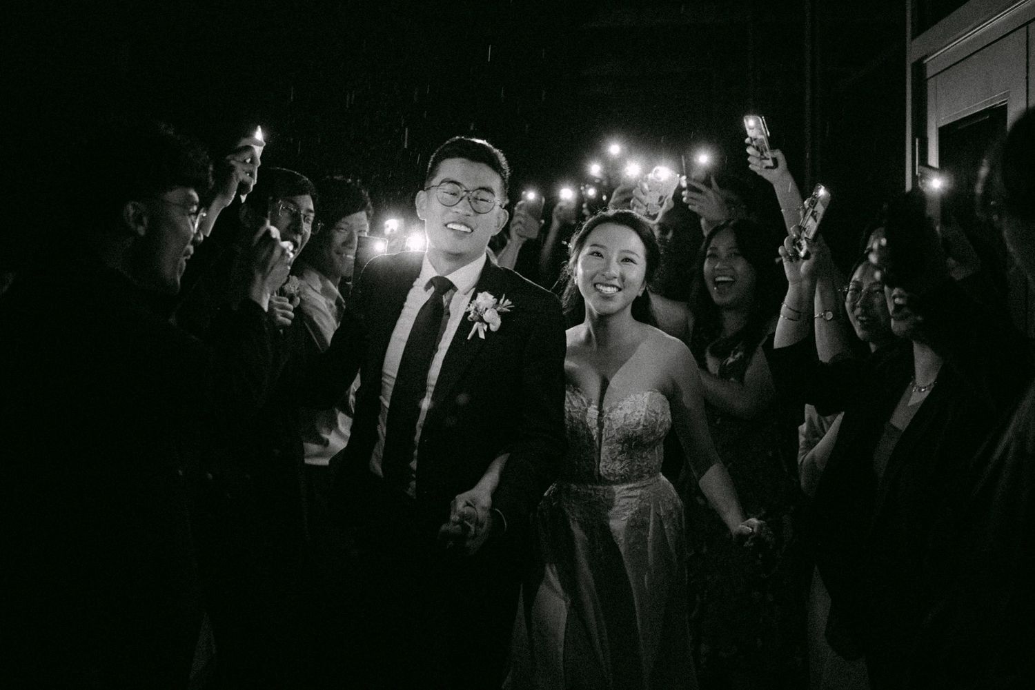 Phone-lit reception exit. Vancouver wedding by Victor Li Photography.