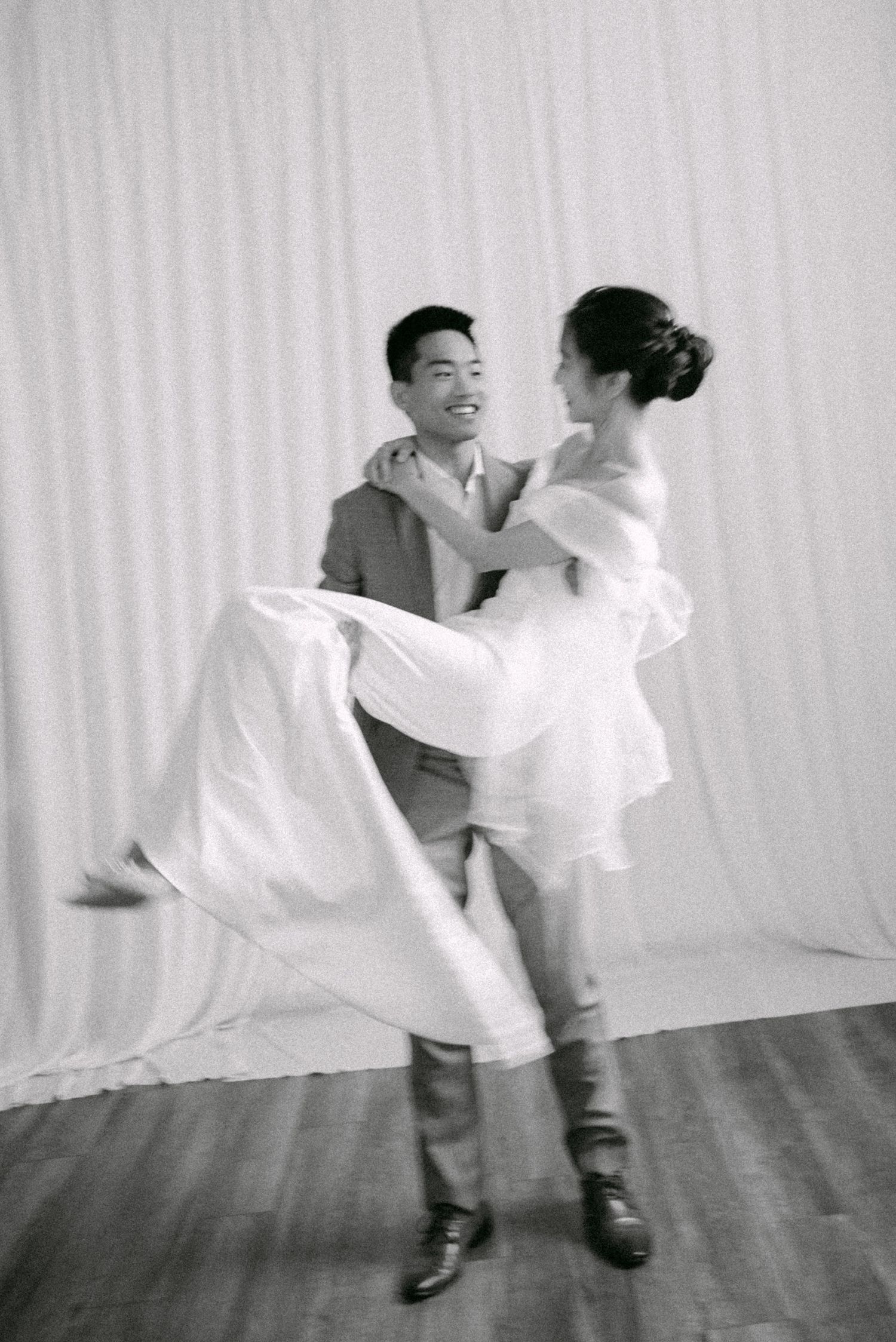 Groom carrying his bride. Vancouver studio prewedding by Victor Li Photography.