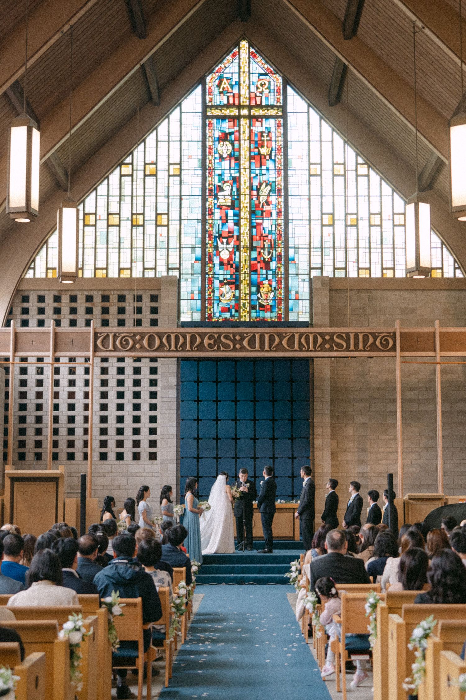 Wedding ceremony in the stained glass cathedral of Shaughnessy Heights United Church. Vancouver wedding by Victor Li Photography.
