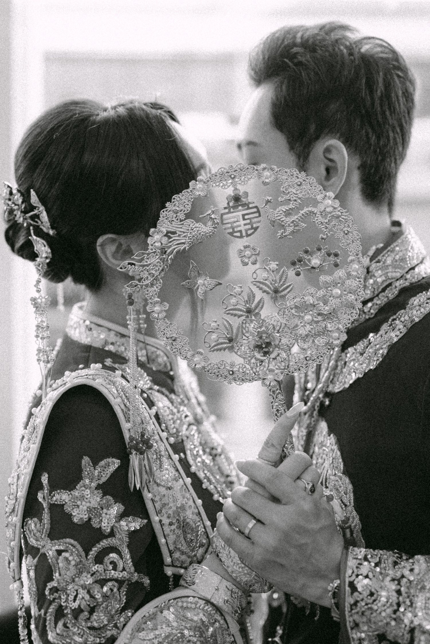 Bride and groom kissing at tea ceremony. Vancouver wedding by Victor Li Photography.
