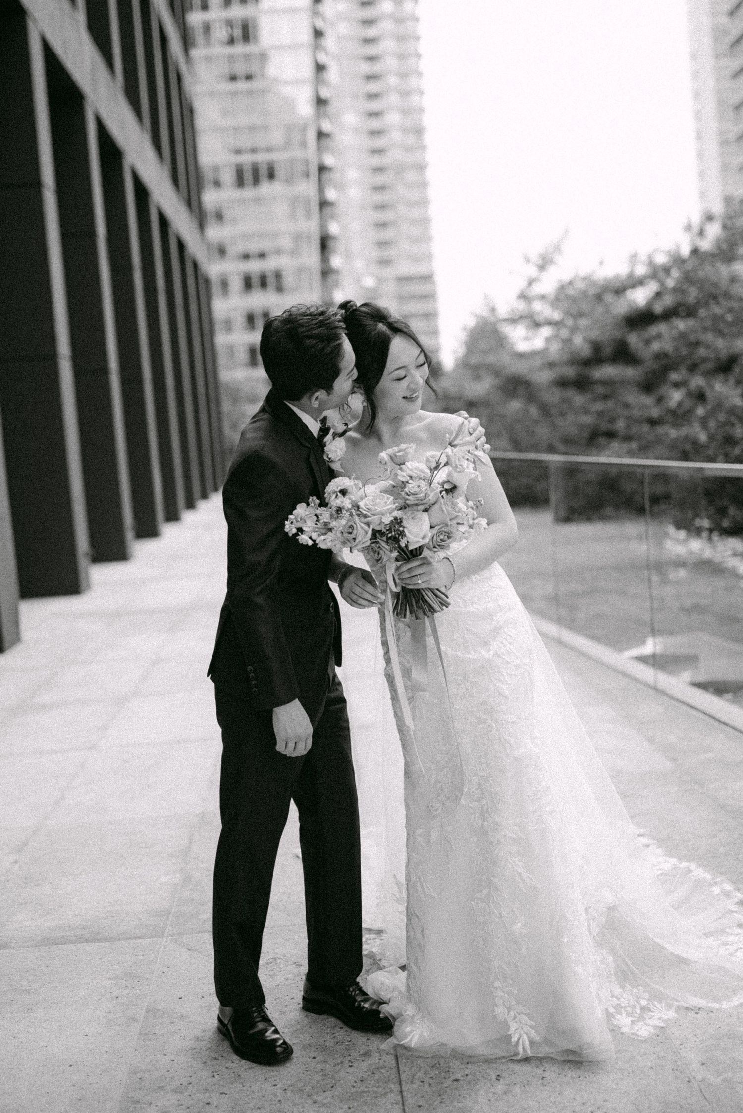 Couple playing kiss tag and teasing each other. Vancouver wedding by Victor Li Photography.