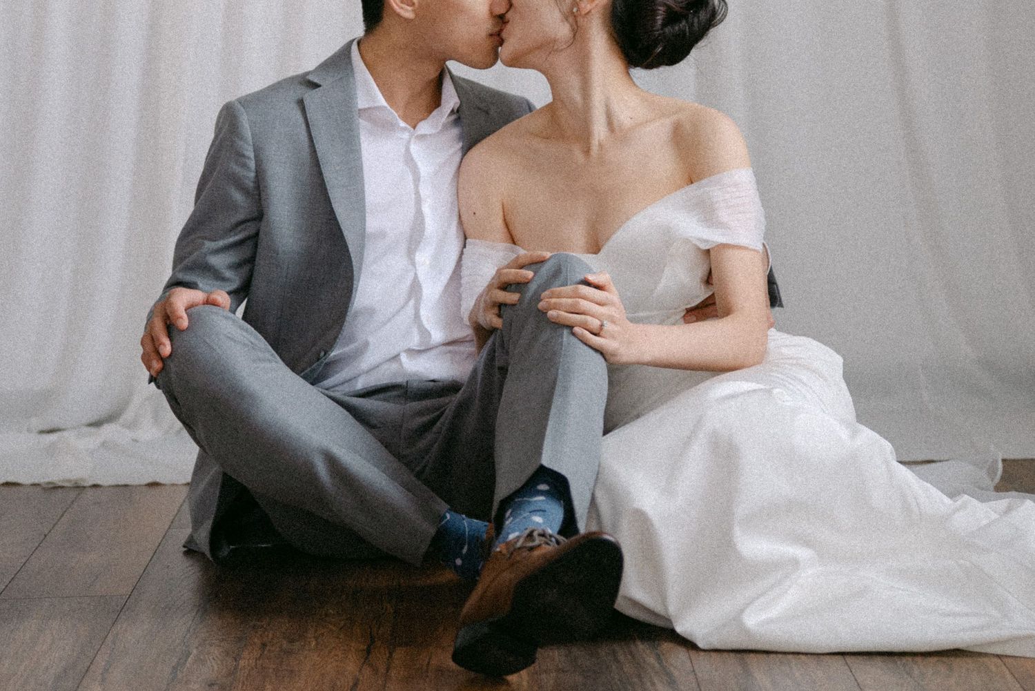 Close-up of couple sitting and kissing. Vancouver studio prewedding by Victor Li Photography.