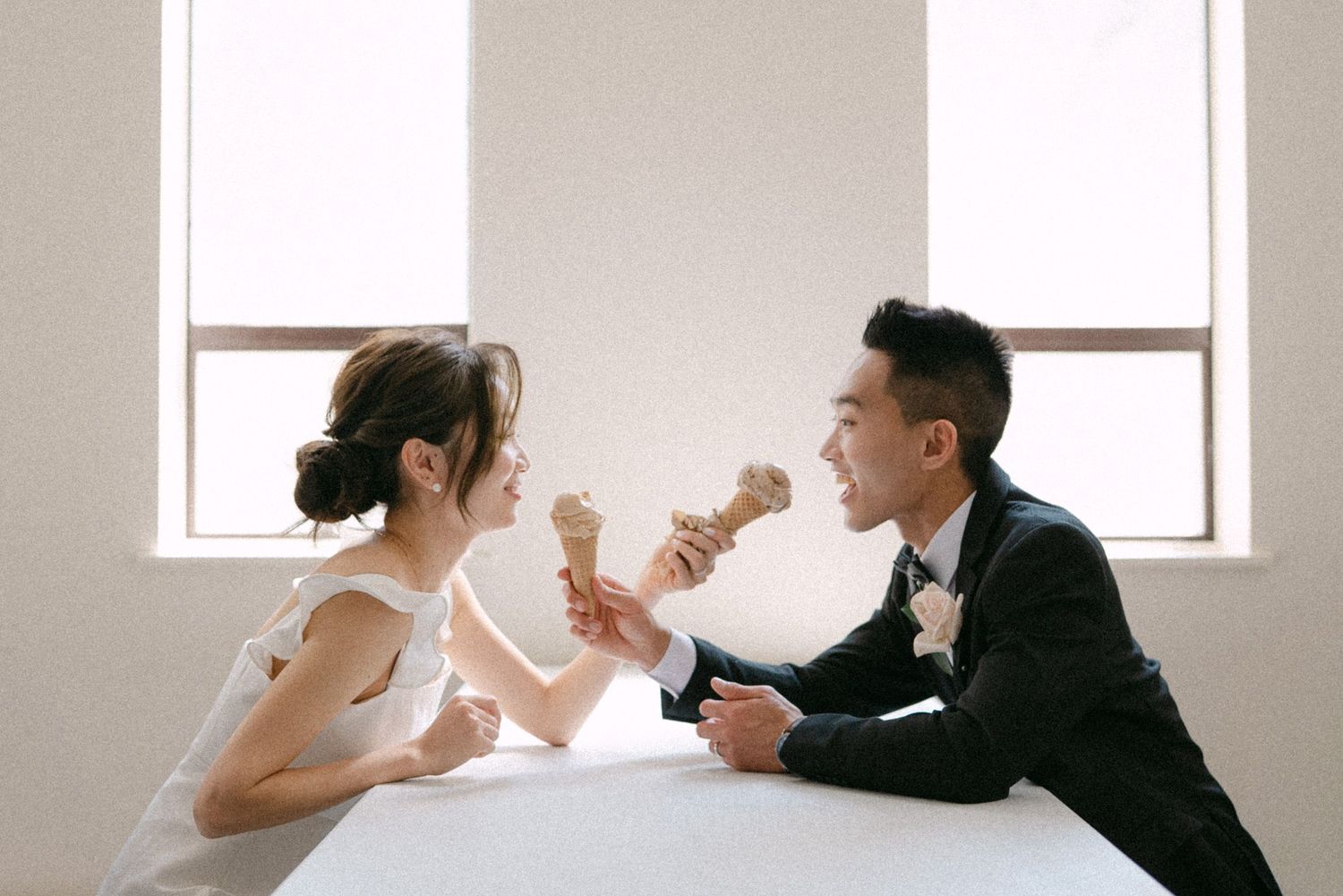 Bride and groom sharing Earnest ice cream. Vancouver wedding by Victor Li Photography.