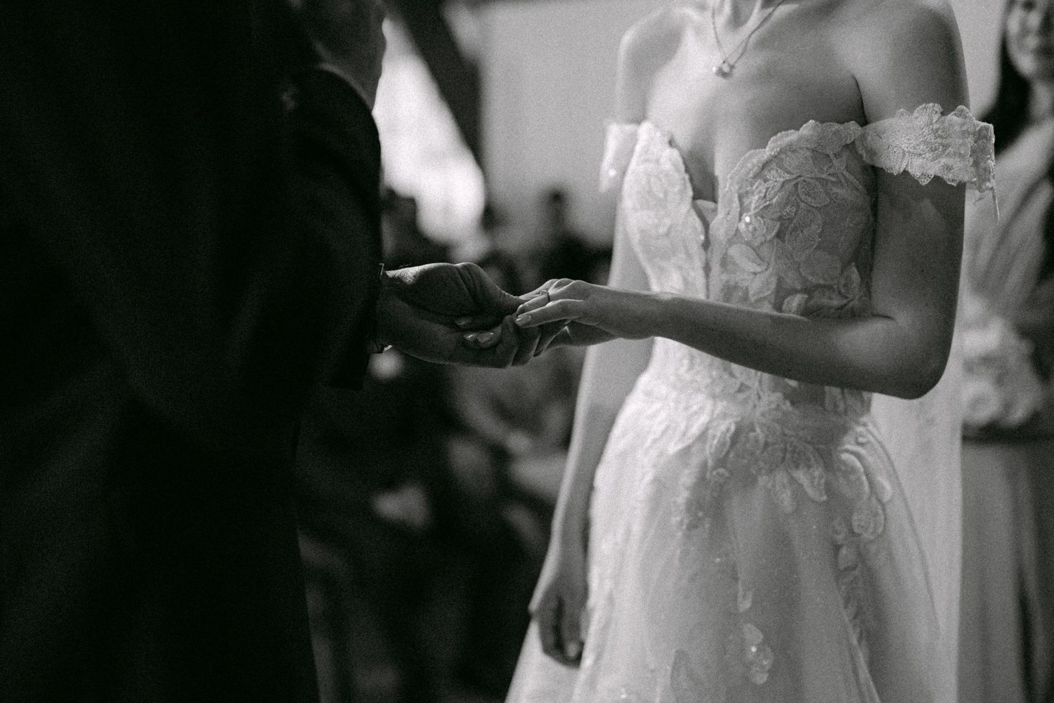 Close-up of groom putting ring on bride. Vancouver wedding by Victor Li Photography.