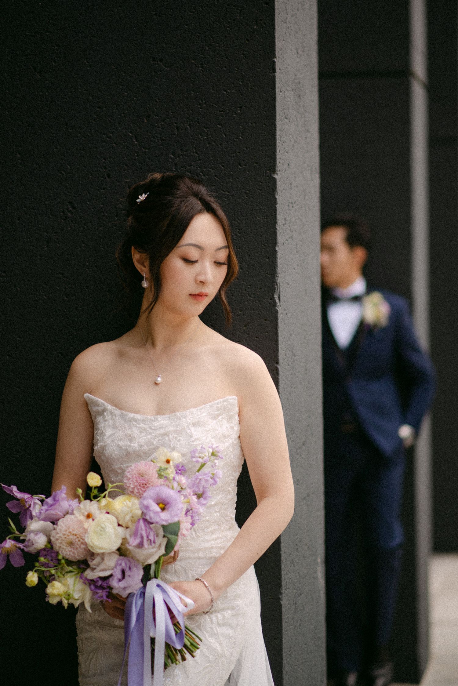 Bride portrait with groom in background. Vancouver wedding by Victor Li Photography.