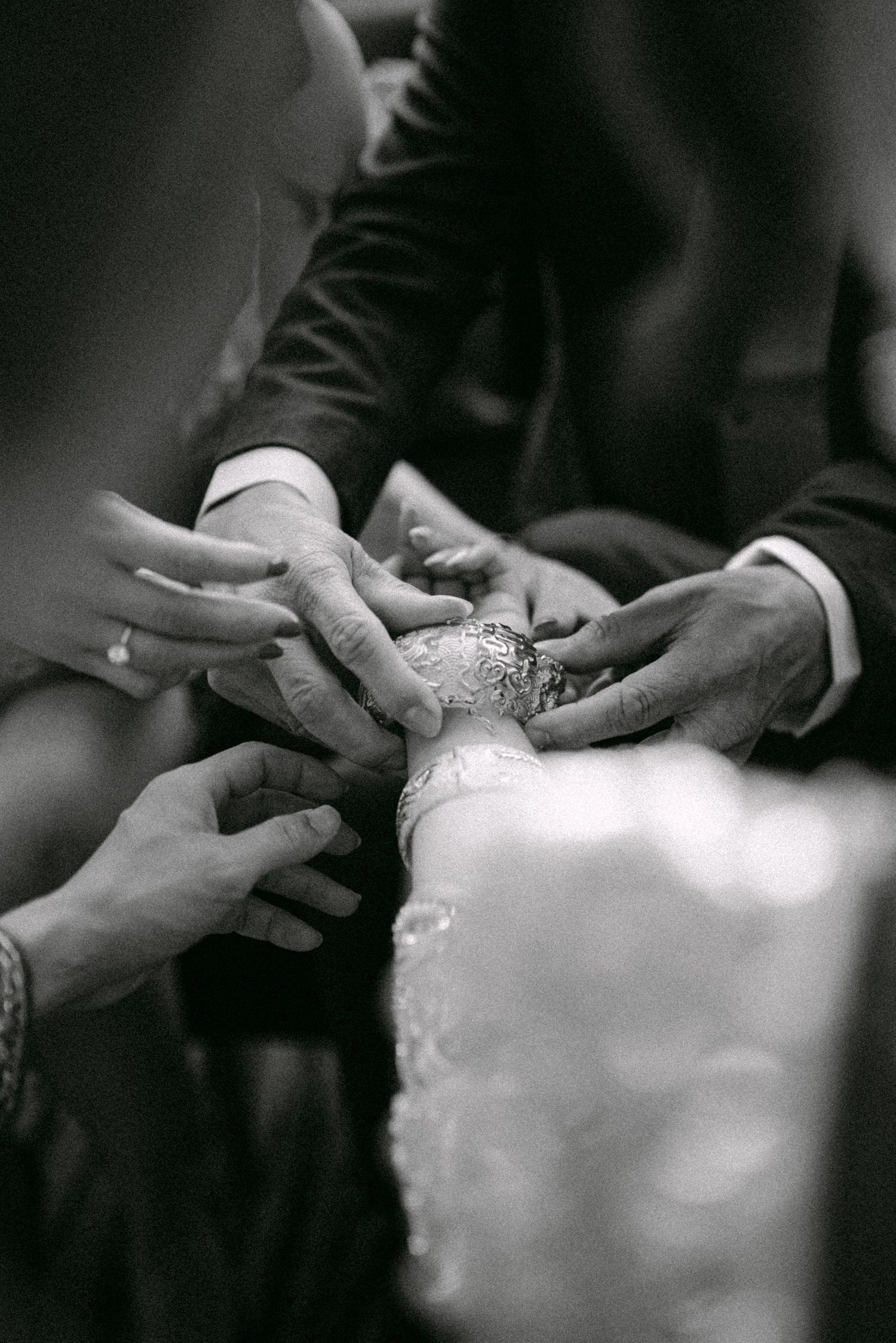 Bride receiving dragon and phoenix bracelets at tea ceremony. Vancouver wedding by Victor Li Photography.