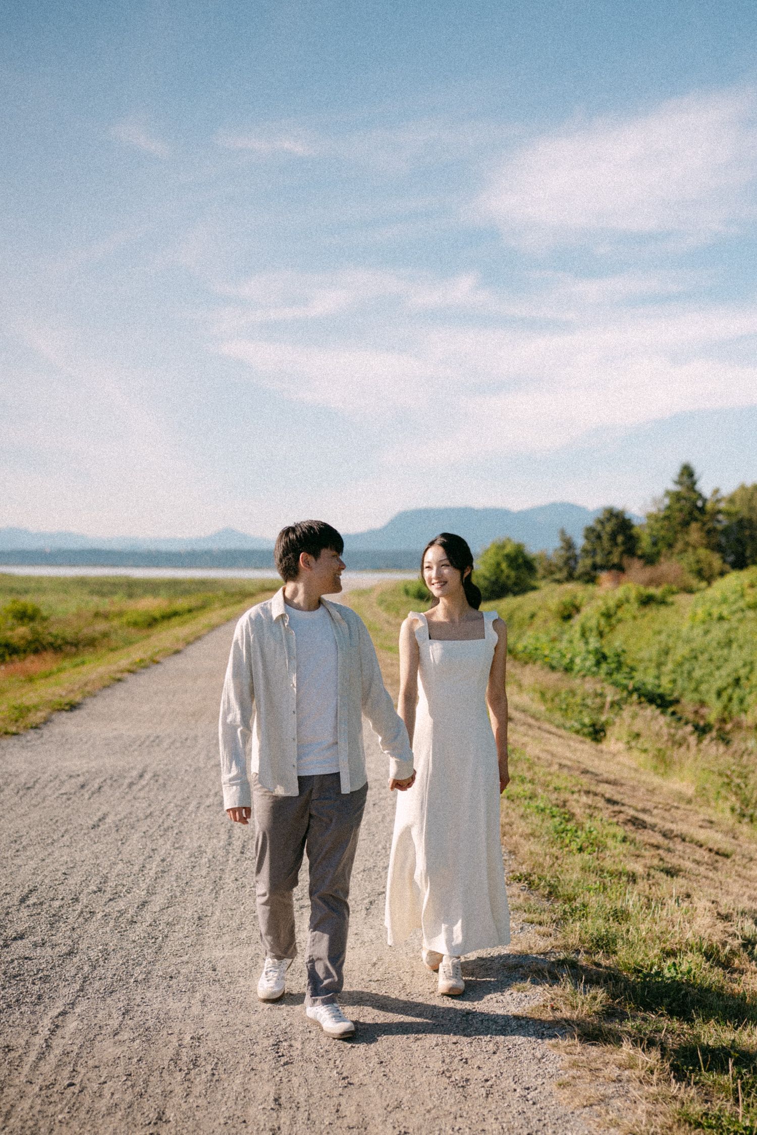 Couple walking along path at Terra Nova Park. Vancouver prewedding and engagement by Victor Li Photography.