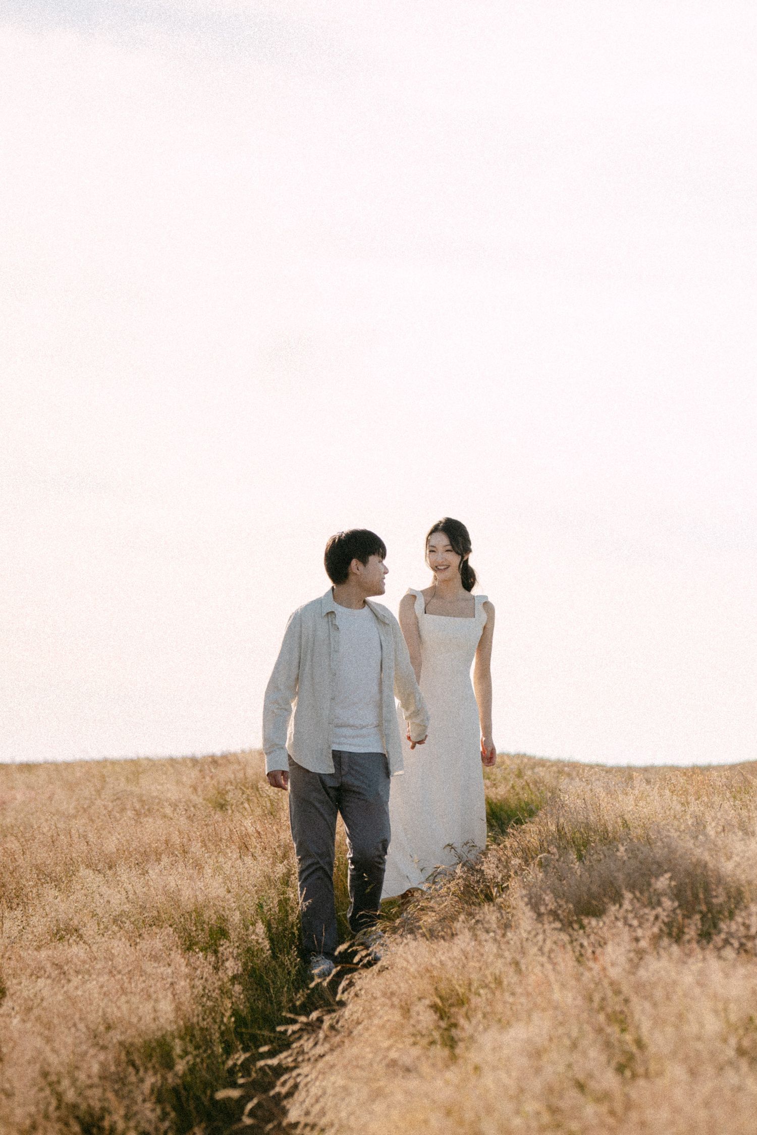 Couple walking down path at Terra Nova Park. Vancouver prewedding and engagement by Victor Li Photography.