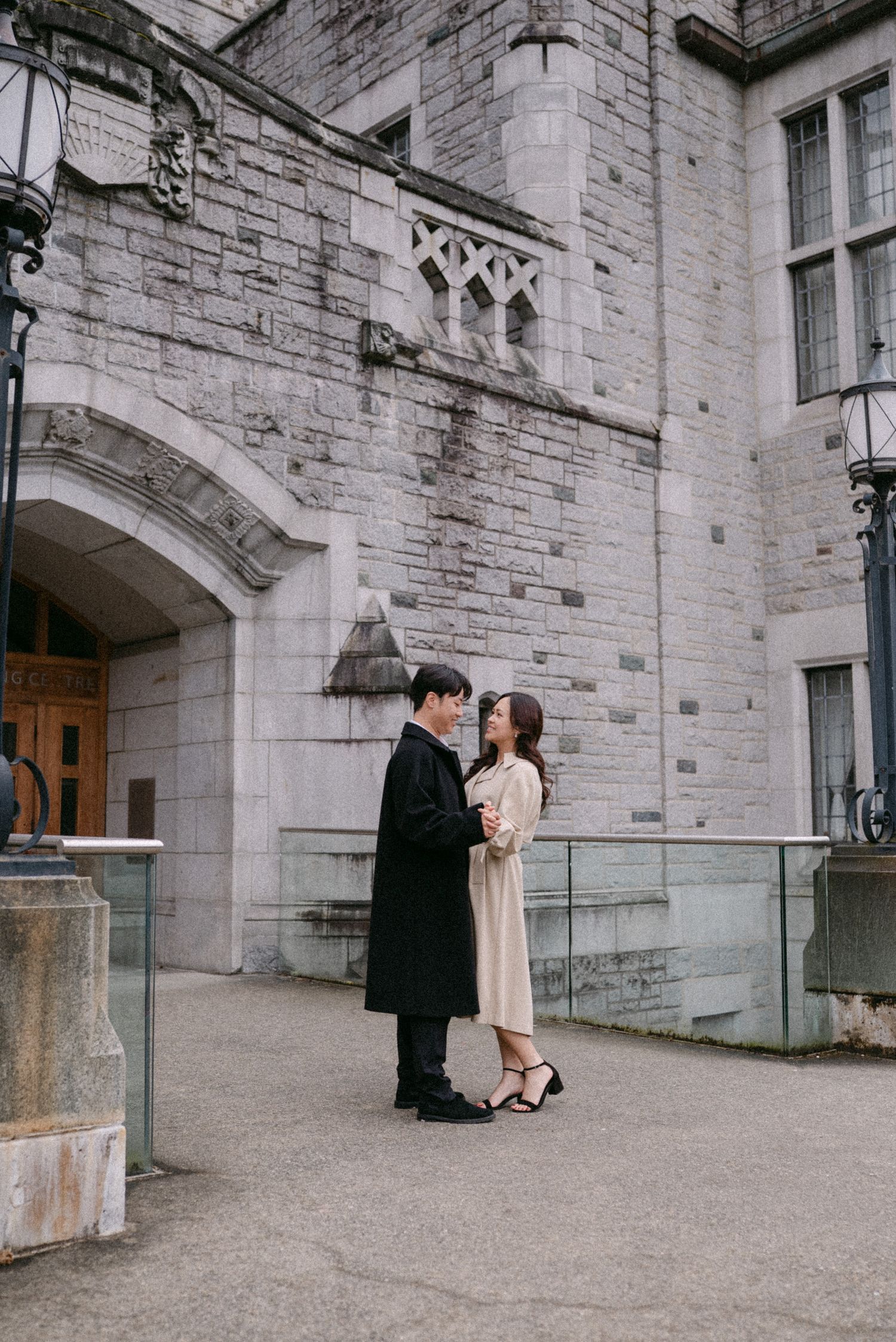 Couple dances in front of UBC Irving. Vancouver engagement by Victor Li Photography.
