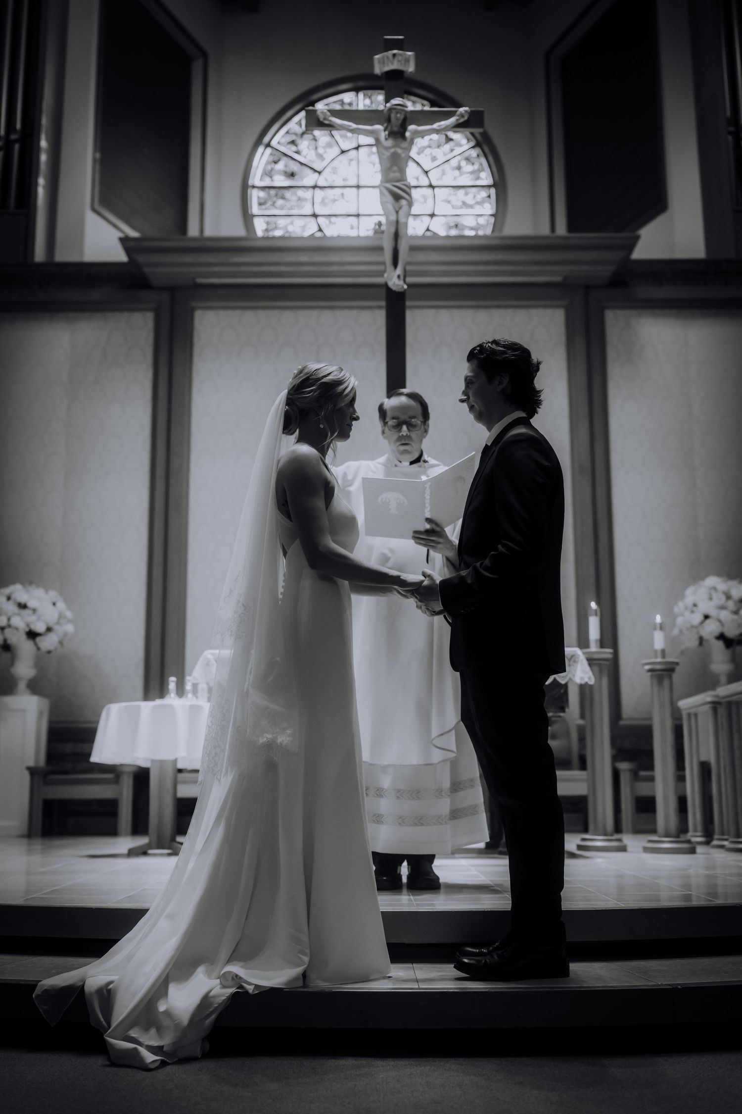 A black and white wedding scene sequence showing a couple dancing together in an elegant room with arched windows.