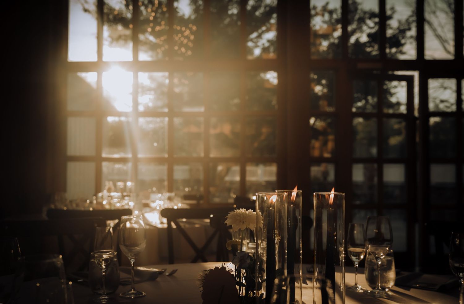 Golden sunset light streams through windows creating a warm atmospheric glow.