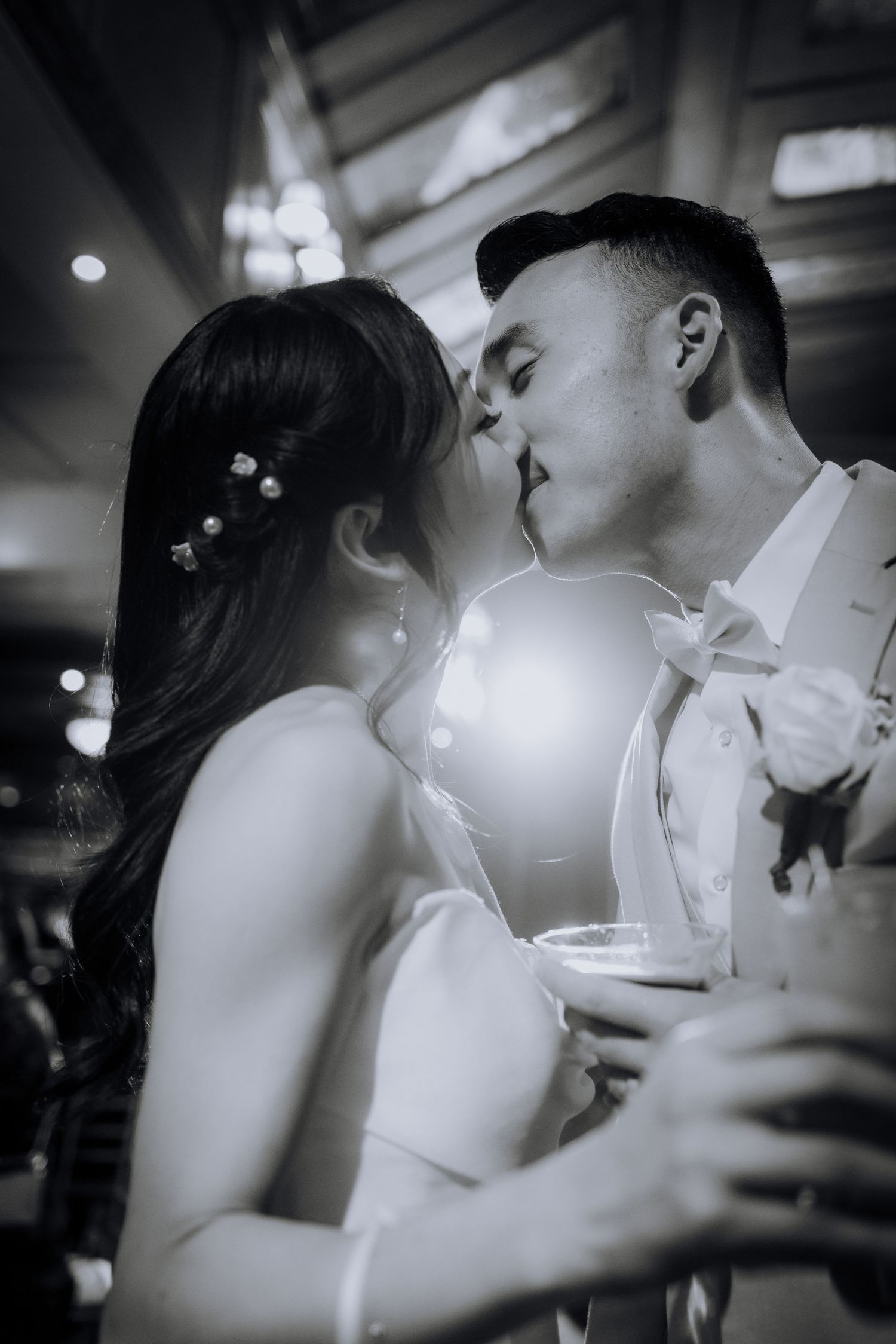 Black and white romantic moments captured during a wedding reception.