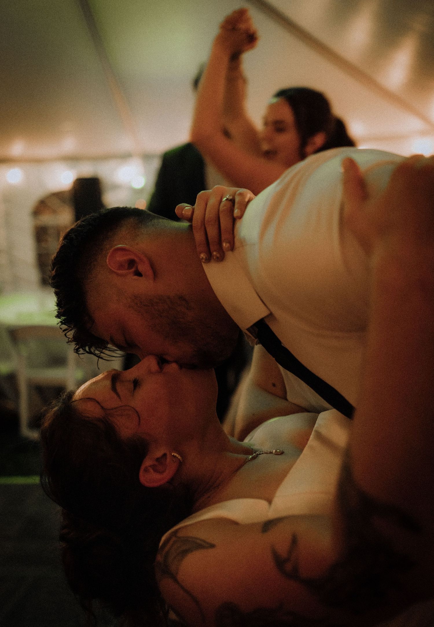 Intimate dance floor moment at wedding reception with warm lighting.