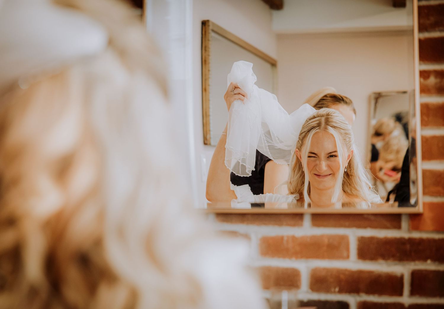 Candid wedding photos show happy moments between couple and guests at a rustic venue with warm lighting and wood beams.