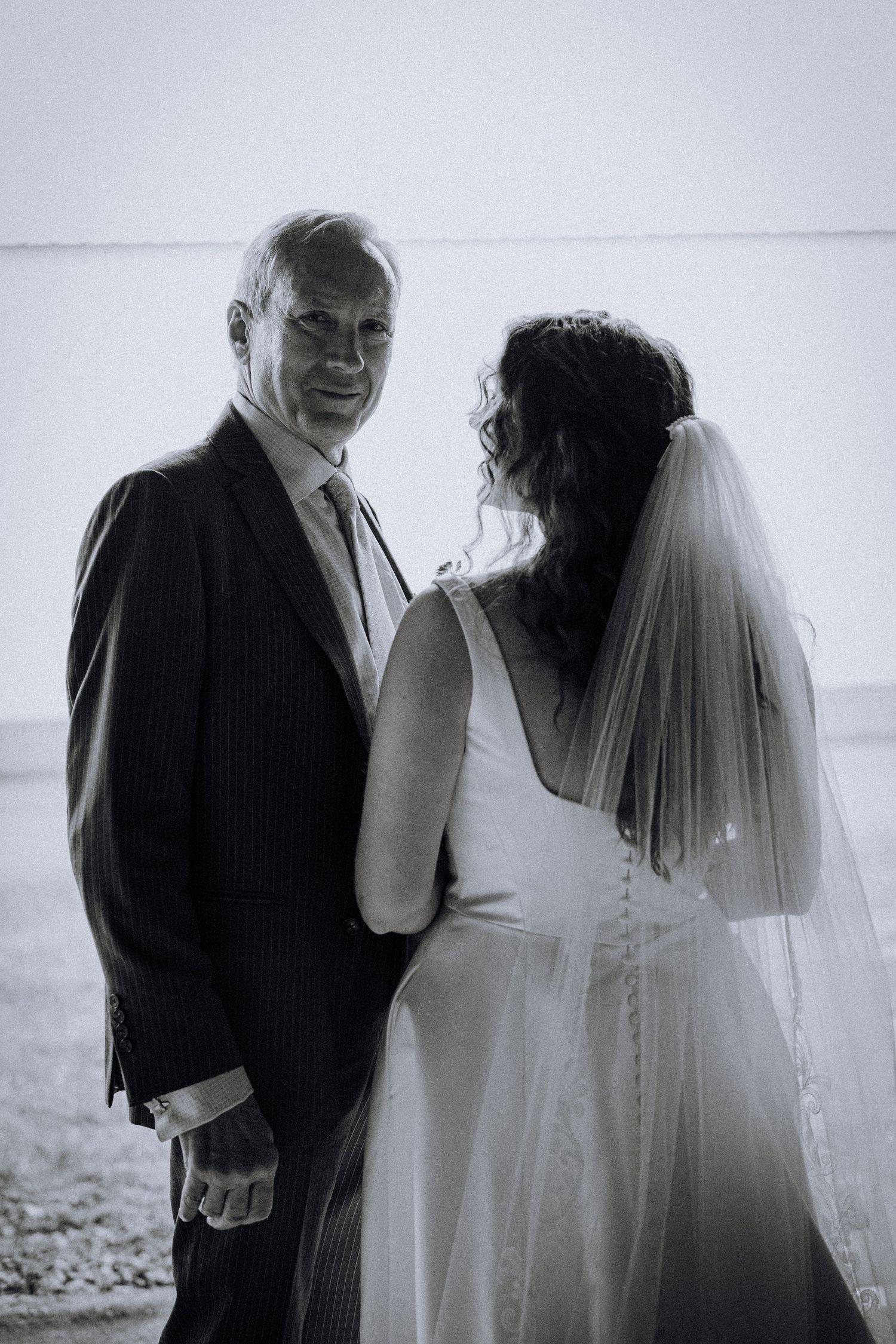 Black and white wedding photos show intimate moments between a couple in romantic poses.