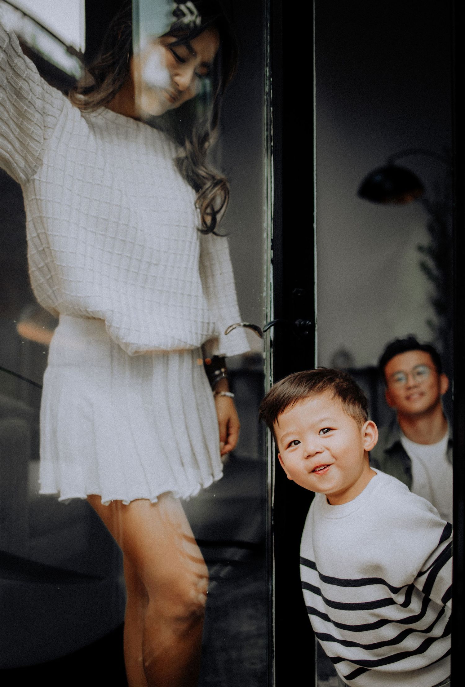 A series of artistic photos showing movement and interaction between people wearing white and striped clothing.