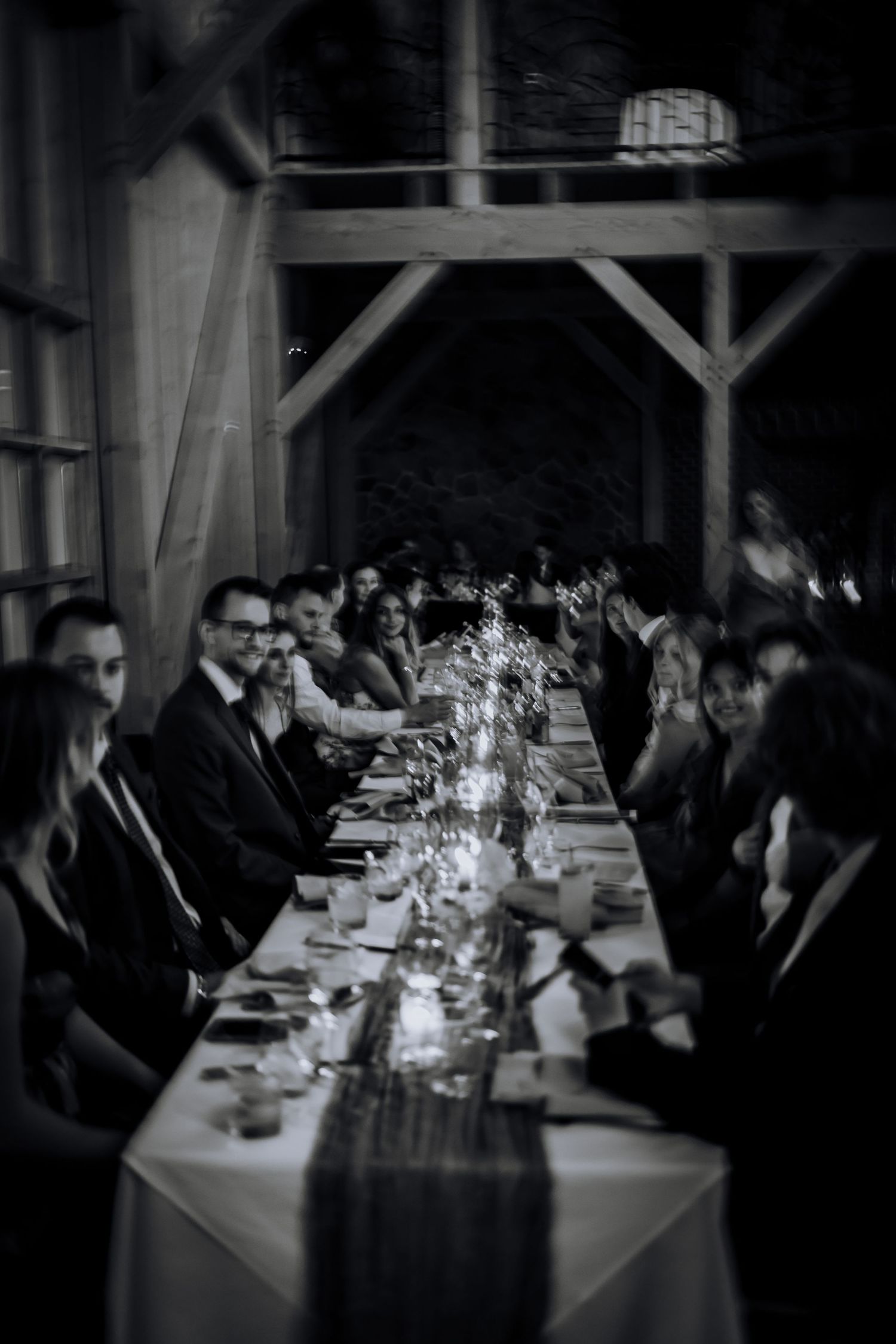 Wedding guests seated at long tables during an elegant evening reception.