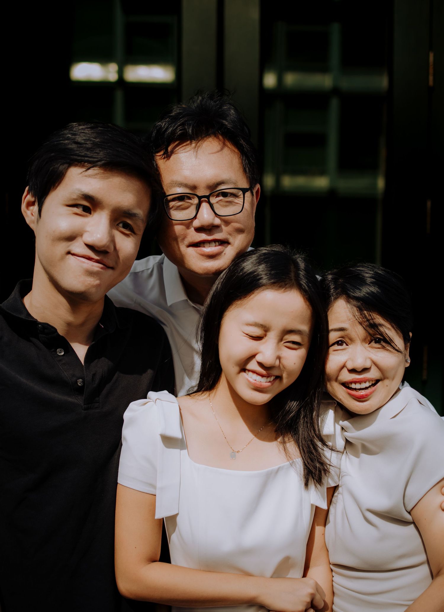 A group wearing white shirts poses together for casual photos.