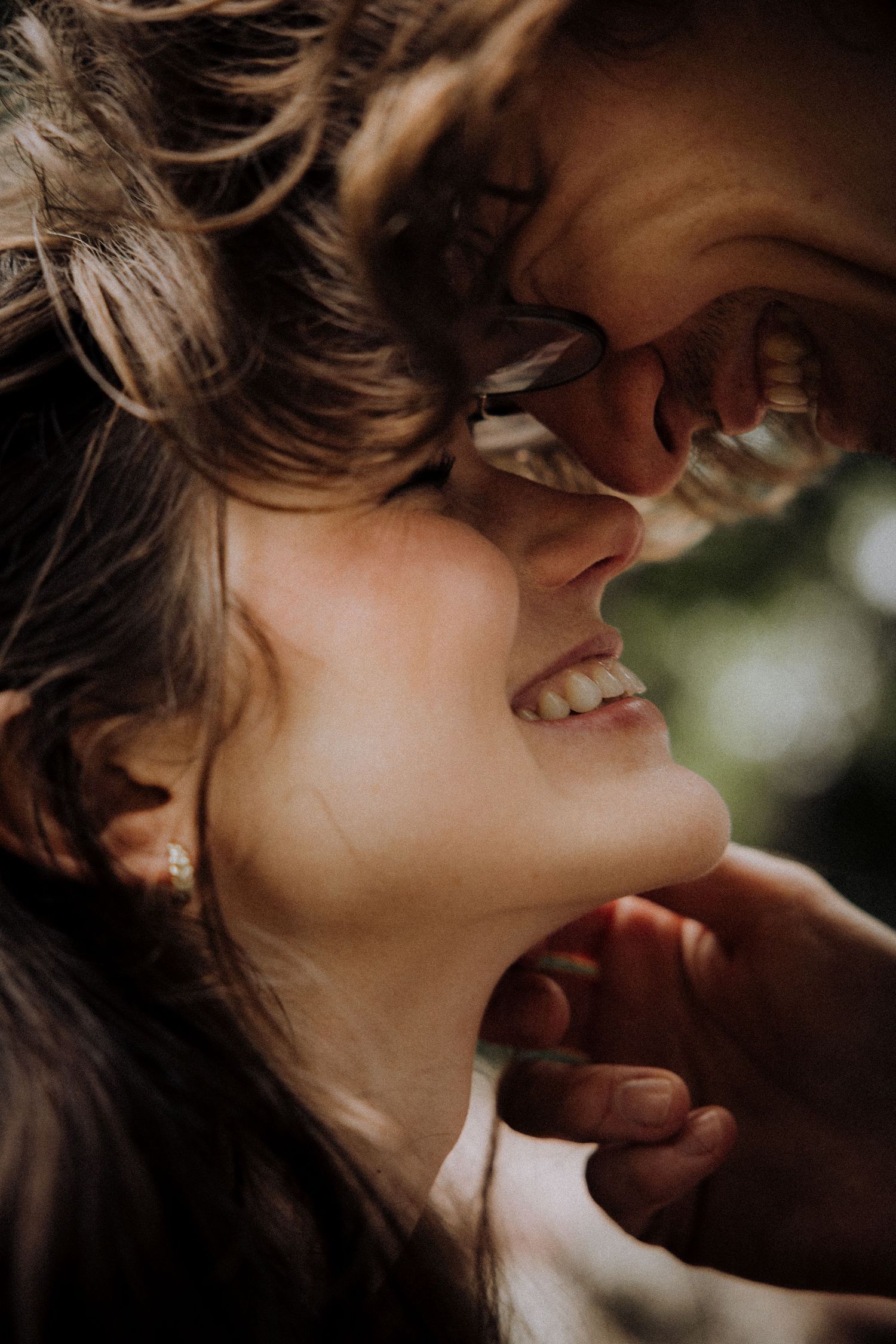 Intimate close-up portrait series showing tender romantic moments in moody lighting.