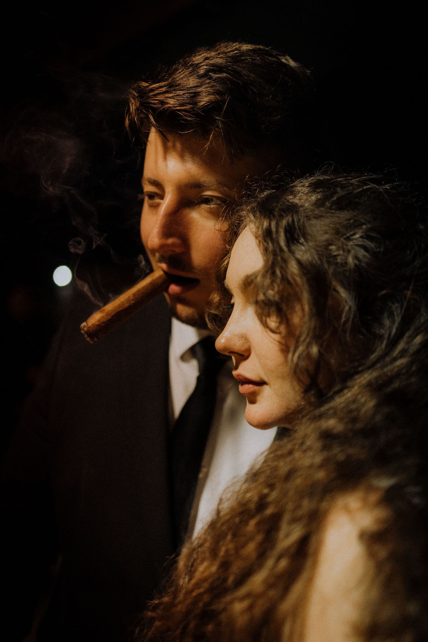 Dramatic moody lighting creates film noir atmosphere at an elegant evening event.