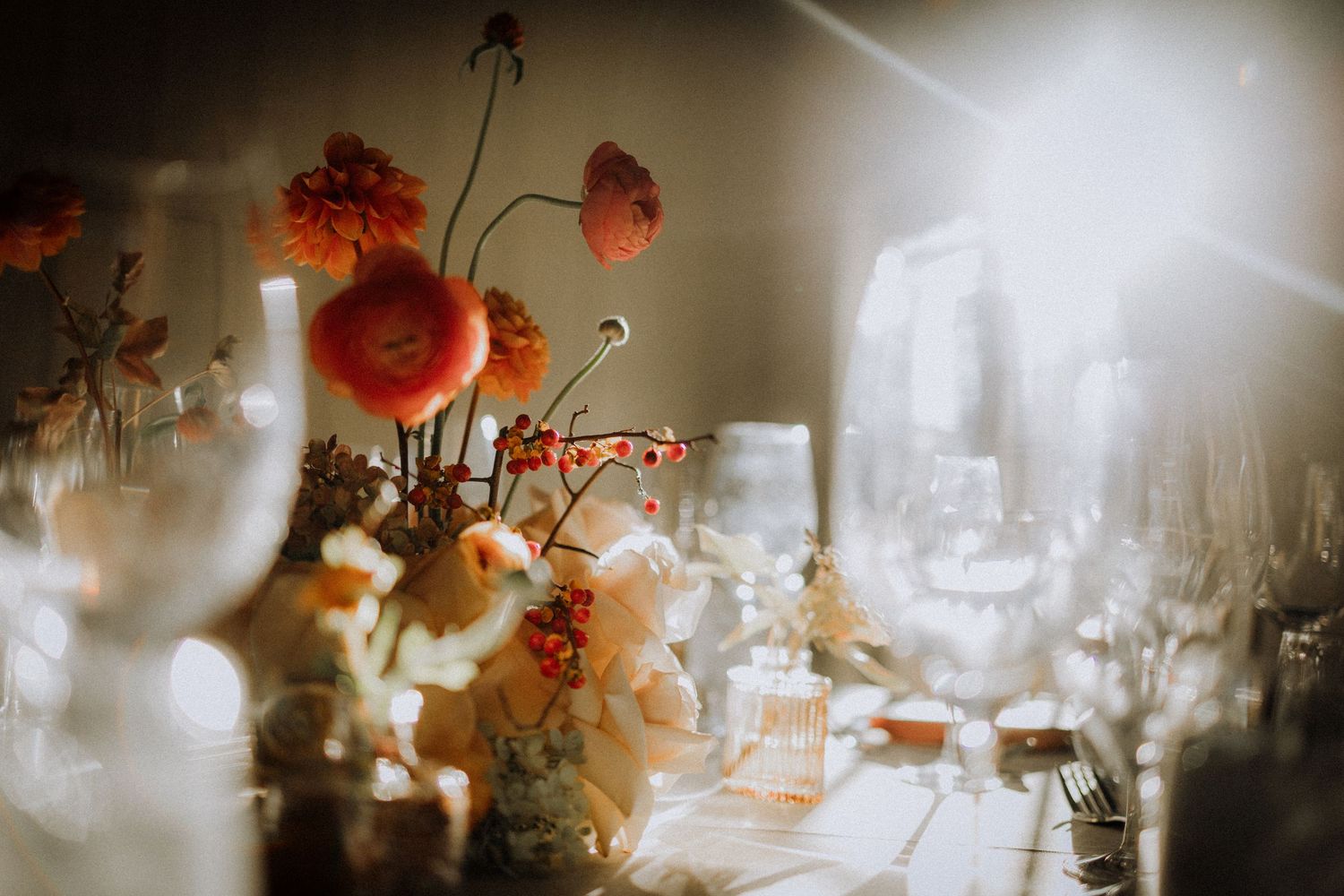 Ethereal wedding reception table setting with glowing candles and floral arrangements.