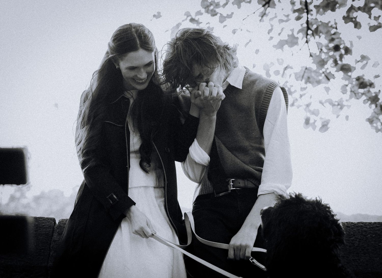 A tender black and white moment shared between a couple outdoors.