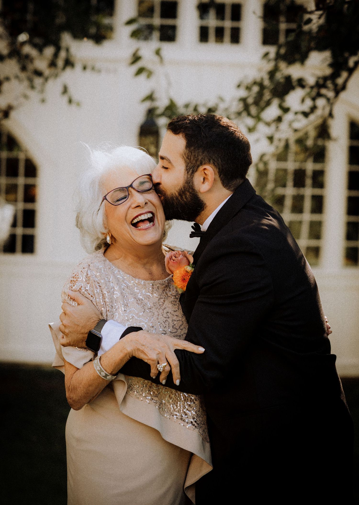 Joyful laughter shared between wedding attendees during an outdoor celebration.