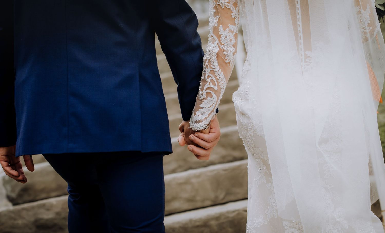 Detail shots of bride's lace dress and romantic moments during ceremony.