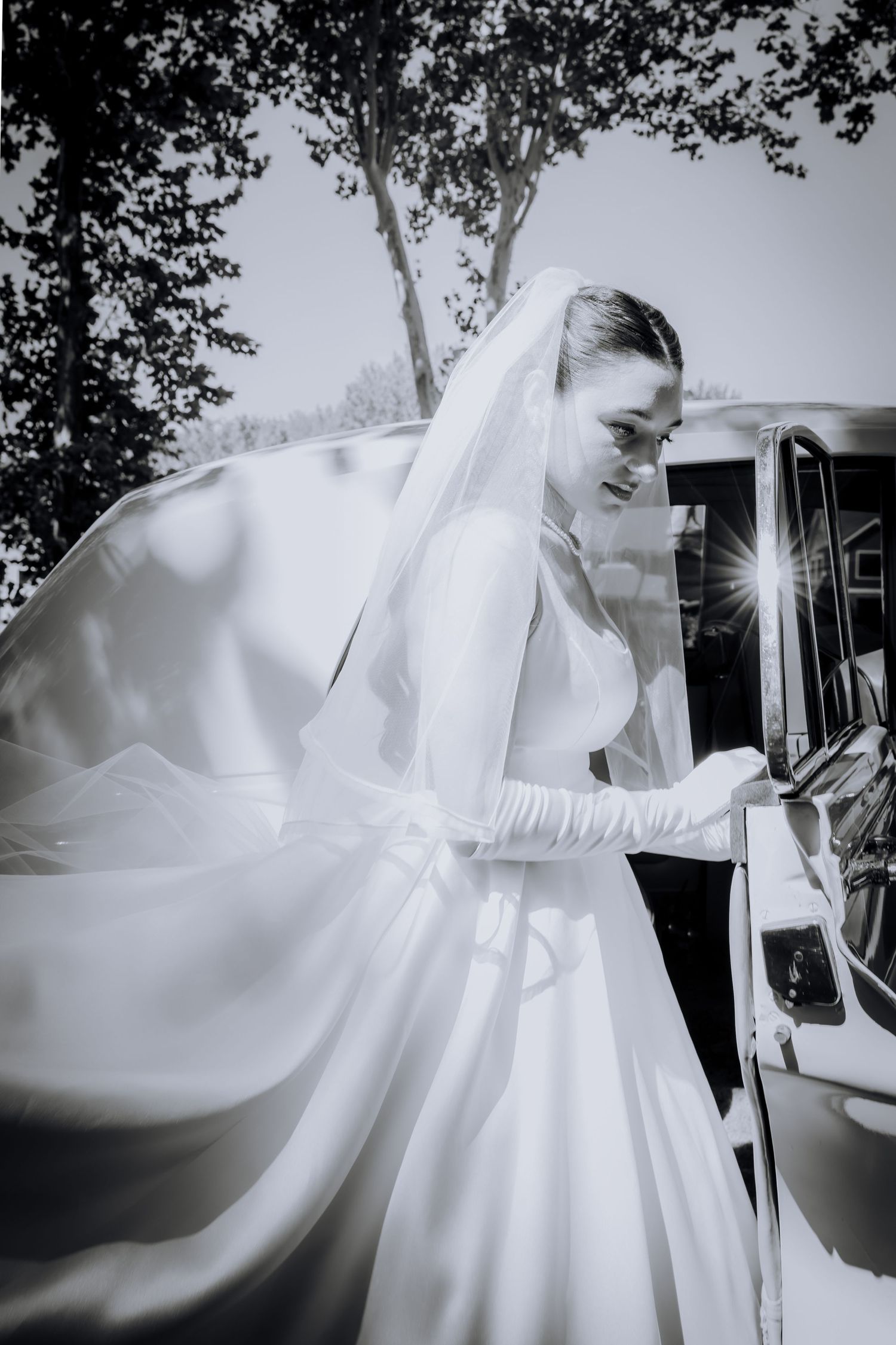 A bride in a flowing white wedding dress moves gracefully through a black and white photo sequence outdoors.