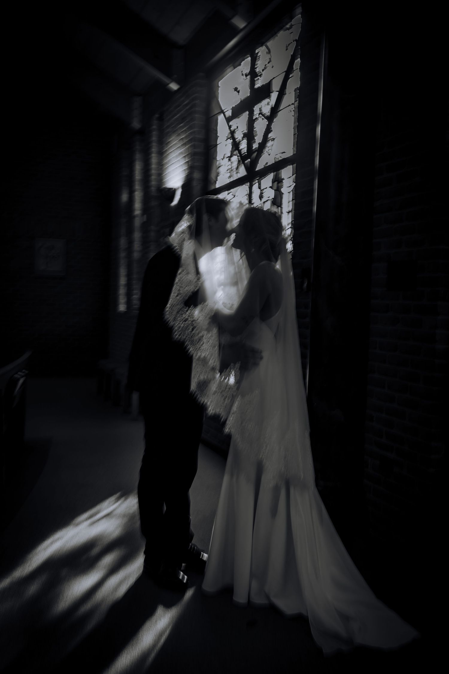 A series of moody black and white wedding photos showing silhouettes in dramatic lighting against a dark corridor.