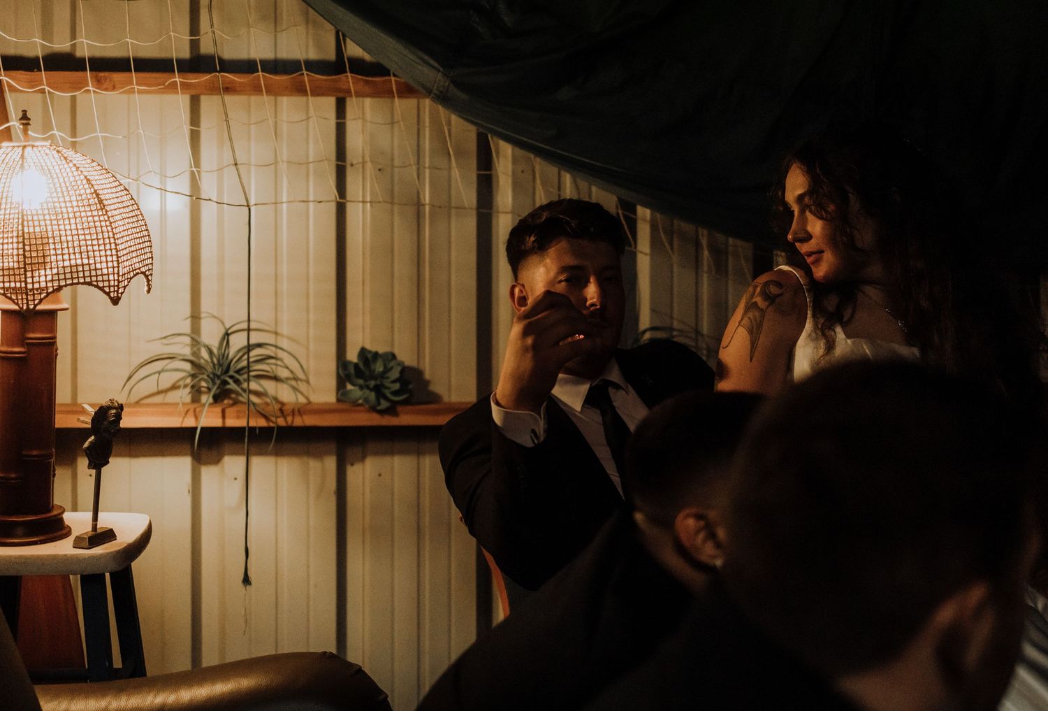 A group of people sitting at a bar counter in a dimly lit restaurant setting.