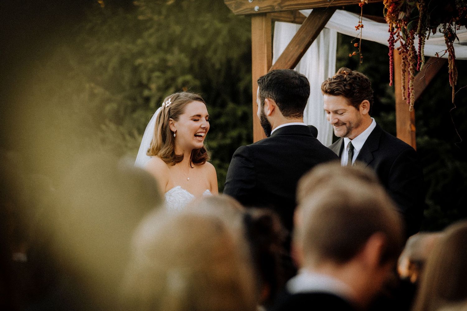 Candid wedding ceremony moment captured during outdoor celebration.