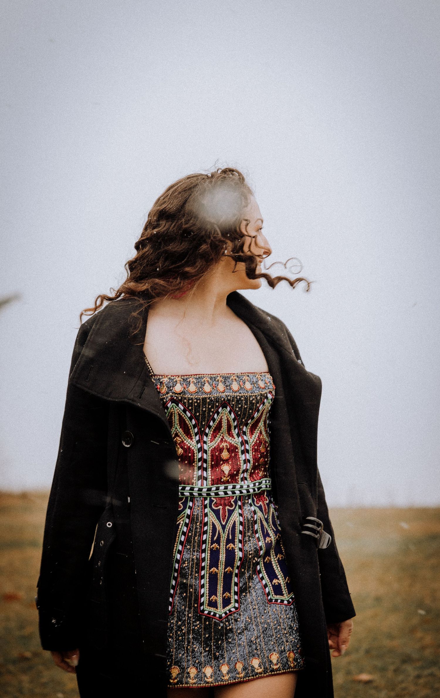 A detailed view of an ornate embroidered bodice with black jacket.