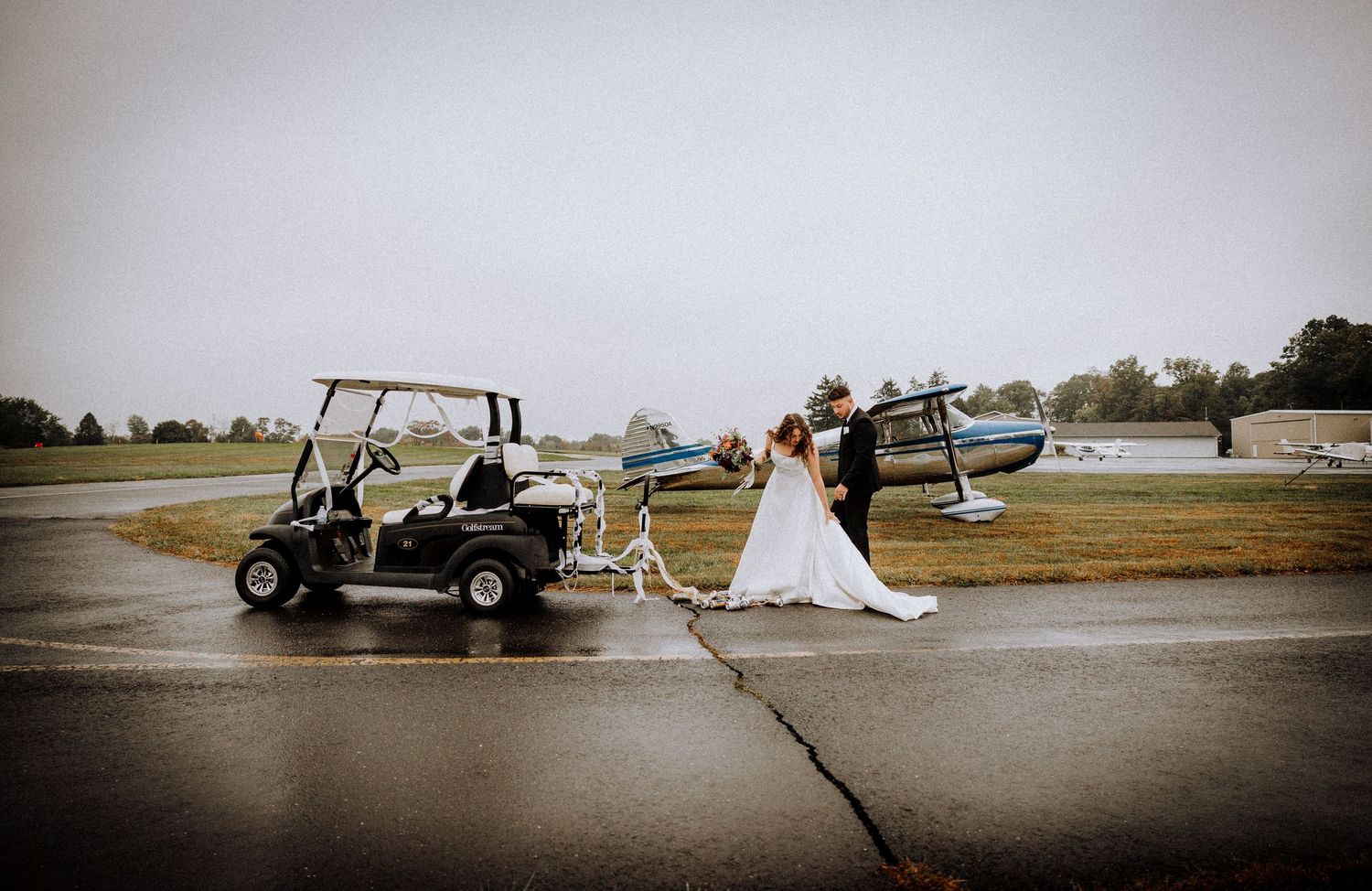 Scenic outdoor wedding photos with vintage vehicles and natural landscape in the background.