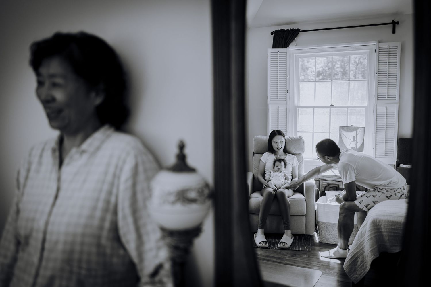 Black and white photo series showing candid moments between family members in a bright interior space.