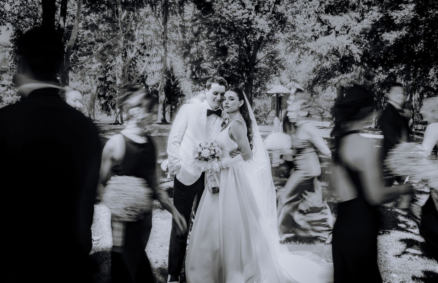 Artistic black and white wedding photography capturing movement and celebration.